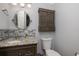 Well-lit bathroom featuring a granite countertop vanity, a mosaic backsplash, and modern fixtures at 4859 Augusta Ave, Oldsmar, FL 34677