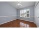 Cozy bedroom with hardwood floors, plantation shutters, and neutral paint, creating a serene atmosphere at 4859 Augusta Ave, Oldsmar, FL 34677