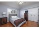 Bright bedroom with shuttered window, hardwood floors, and well sized closet at 4859 Augusta Ave, Oldsmar, FL 34677