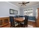 Charming dining room featuring a wooden table with seating for six, complemented by elegant lighting and a large window at 4859 Augusta Ave, Oldsmar, FL 34677