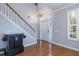 Bright foyer with hardwood floors, a staircase, and a chandelier, offering a welcoming entrance to the home at 4859 Augusta Ave, Oldsmar, FL 34677