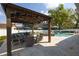 Gazebo in the back yard with ample seating next to the pool and outdoor kitchen at 4859 Augusta Ave, Oldsmar, FL 34677