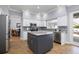 Bright kitchen with a center island, granite countertops, and white cabinets at 4859 Augusta Ave, Oldsmar, FL 34677