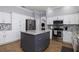 Modern kitchen featuring white cabinets, stainless steel appliances, granite counters and a stylish center island at 4859 Augusta Ave, Oldsmar, FL 34677