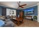 Comfortable living room with a large sectional sofa, ceiling fan, and a wall-mounted TV, creating a cozy atmosphere at 4859 Augusta Ave, Oldsmar, FL 34677