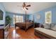Spacious main bedroom with hardwood floors, plantation shutters, and ample natural light at 4859 Augusta Ave, Oldsmar, FL 34677