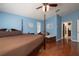 Comfortable main bedroom featuring hardwood floors, a four-poster bed, and a cozy seating area by the window at 4859 Augusta Ave, Oldsmar, FL 34677
