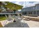 Beautiful outdoor patio with travertine tile, seating and tables, a fire pit, and view of the house at 4859 Augusta Ave, Oldsmar, FL 34677