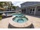 Backyard pool and spa area with a covered patio, lounge chairs, and a well-maintained lawn at 4859 Augusta Ave, Oldsmar, FL 34677