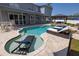 Inviting backyard pool with a tanning ledge, travertine deck, and relaxing outdoor space at 4859 Augusta Ave, Oldsmar, FL 34677
