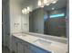 Double vanity bathroom featuring modern fixtures and a well lit mirror at 5014 Coastal Oak Ct, Lakewood Ranch, FL 34211