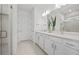 Bright bathroom features double sinks, modern fixtures, and glass enclosed shower at 5014 Coastal Oak Ct, Lakewood Ranch, FL 34211