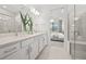 Bright bathroom features double sinks, modern fixtures, a glass enclosed shower, and bedroom view at 5014 Coastal Oak Ct, Lakewood Ranch, FL 34211