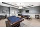 A billiards room featuring two pool tables and seating area, perfect for relaxation and socializing at 5014 Coastal Oak Ct, Lakewood Ranch, FL 34211