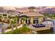 Exterior view of clubhouse with outdoor seating, overlooking the lake, and lush tropical landscaping at 5014 Coastal Oak Ct, Lakewood Ranch, FL 34211