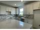 Modern kitchen featuring white cabinets, quartz countertops, and stylish backsplash at 5014 Coastal Oak Ct, Lakewood Ranch, FL 34211