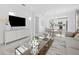 Bright living room with a large TV, stylish furniture, and modern lighting at 5014 Coastal Oak Ct, Lakewood Ranch, FL 34211