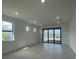 Spacious living room featuring tile floors, recessed lighting, and sliding glass doors at 5014 Coastal Oak Ct, Lakewood Ranch, FL 34211
