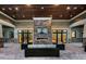 Elegant lounge area with a stone fireplace, comfortable seating, and inviting atmosphere at 5014 Coastal Oak Ct, Lakewood Ranch, FL 34211