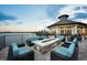 Community outdoor fireplace area with cozy seating offering stunning lake views and tranquil ambiance at 5014 Coastal Oak Ct, Lakewood Ranch, FL 34211