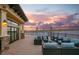 Outdoor seating area with comfortable wicker furniture, overlooks the lake, offering picturesque views at 5014 Coastal Oak Ct, Lakewood Ranch, FL 34211