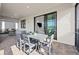 Covered patio with outdoor dining set and sliding glass doors to the interior at 5014 Coastal Oak Ct, Lakewood Ranch, FL 34211