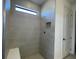 Tiled shower featuring a built-in niche and bench seating at 5014 Coastal Oak Ct, Lakewood Ranch, FL 34211