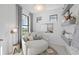 Cozy sitting area features a comfortable chair and decorative shelves at 5014 Coastal Oak Ct, Lakewood Ranch, FL 34211