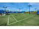 Brightly lit tennis court with shaded seating for players and spectators to enjoy their matches at 5014 Coastal Oak Ct, Lakewood Ranch, FL 34211