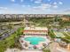 Beautiful aerial shot showing a building, pool, shuffleboard court, and surrounding lush landscape at 5200 Brittany Dr. S # 706, St Petersburg, FL 33715