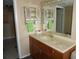 Bathroom with marble counters, decorative shelves, and soft natural light at 5200 Brittany Dr. S # 706, St Petersburg, FL 33715