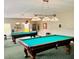 Well-lit billiard room featuring two pool tables with overhead lighting for a comfortable gaming experience at 5200 Brittany Dr. S # 706, St Petersburg, FL 33715