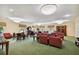 Inviting common room features comfortable seating, ample lighting, and a cozy atmosphere for residents at 5200 Brittany Dr. S # 706, St Petersburg, FL 33715