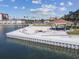 Beautiful private beach with lounging area, benches, tables and a fire pit with buildings in the background at 5200 Brittany Dr. S # 706, St Petersburg, FL 33715
