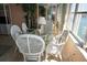 Bright dining area with glass table, chandelier, and elegant white rattan furniture at 5200 Brittany Dr. S # 706, St Petersburg, FL 33715