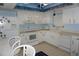 Cozy kitchen featuring white appliances, cabinets, and a fish-themed ceiling border at 5200 Brittany Dr. S # 706, St Petersburg, FL 33715
