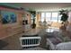 Bright living room features tile floors, coastal decor, and large windows with water views at 5200 Brittany Dr. S # 706, St Petersburg, FL 33715