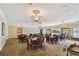 Elegant meeting room with chandelier lighting, multiple tables and chairs, and views of lush landscapes at 5200 Brittany Dr. S # 706, St Petersburg, FL 33715