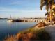 Serene water view featuring a pier, sailboats, and lush greenery along the waterfront at 5200 Brittany Dr. S # 706, St Petersburg, FL 33715