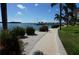 Scenic waterfront view with lush landscaping, a walkway, and a tranquil view of the water and docks at 5200 Brittany Dr. S # 706, St Petersburg, FL 33715