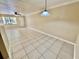 Spacious living room featuring neutral-toned walls, tile flooring, and a ceiling fan at 5221 Bayshore Blvd # 29, Tampa, FL 33611