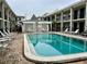 Community pool surrounded by seating and patio area in a courtyard at 5221 Bayshore Blvd # 29, Tampa, FL 33611