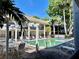 Community pool with chairs in a courtyard with palm trees and two-story building at 5221 Bayshore Blvd # 29, Tampa, FL 33611