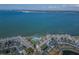 Stunning aerial view of waterfront condos with a pool, tennis courts, and pristine water views at 5277 Isla Key S Blvd # 422, St Petersburg, FL 33715