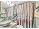Bathroom featuring a distinctive sink bowl, a mirror, and a charming shower curtain at 5277 Isla Key S Blvd # 422, St Petersburg, FL 33715