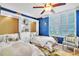 Charming bedroom featuring two twin beds, a built-in bookcase, and bright natural light from shuttered windows at 5277 Isla Key S Blvd # 422, St Petersburg, FL 33715