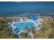 Aerial view of a sparkling pool with lounge chairs, palm trees, and expansive water views at 5277 Isla Key S Blvd # 422, St Petersburg, FL 33715