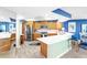 Well-lit kitchen featuring modern appliances, granite countertops, wood cabinets and eat-in counter at 5277 Isla Key S Blvd # 422, St Petersburg, FL 33715