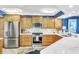 Kitchen showcasing stainless steel appliances, light wood cabinets, and granite countertops at 5277 Isla Key S Blvd # 422, St Petersburg, FL 33715