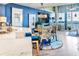 Open concept living area with dining, kitchen, marble counters, and stylish blue accents at 5277 Isla Key S Blvd # 422, St Petersburg, FL 33715